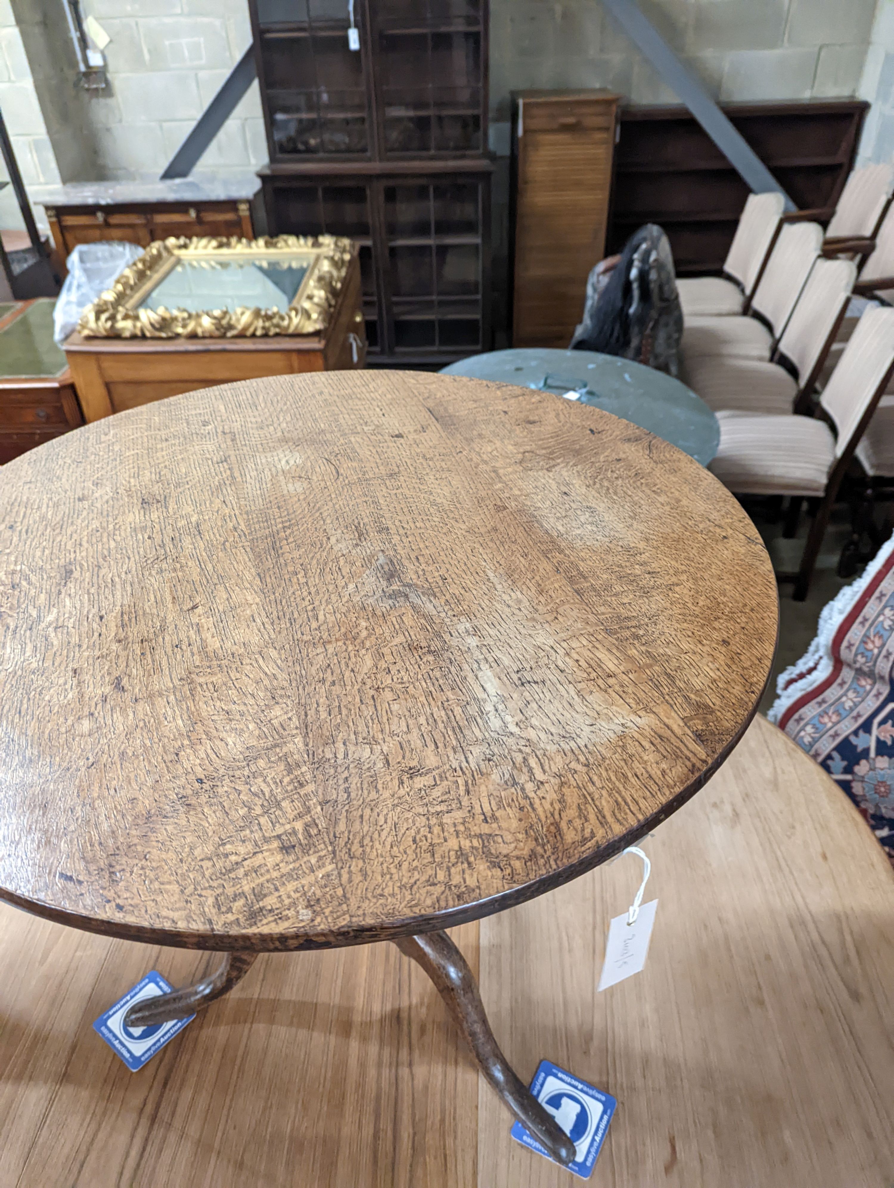 A George III circular oak tilt top tea table, diameter 74cm, height 66cm